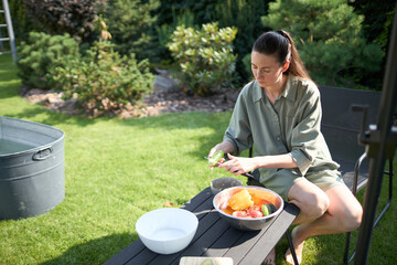 Woman cooking in her backyard