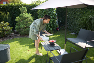 Woman cooking in her backyard