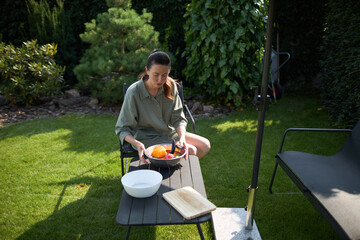 Woman cooking in her backyard