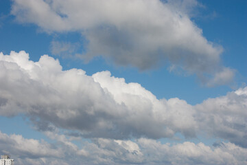 Blue sky and white clouds. Daytime sky. Sky background for background, post, screensaver, wallpaper, postcard, banner, cover, website