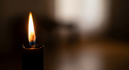 Close-up of a single black candle flame symbolizing unity and reflection during Kwanzaa celebration