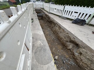 Construction Site Featuring an Exposed Trench for Essential Utility Work Being Conducted