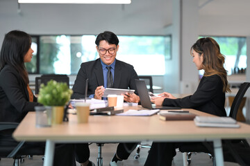 Group of businesspeople collaborating and exchanging ideas in a bright office