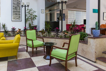 Tekirova, Turkey - June 6, 2025: A cozy place to relax, with beautiful yellow and green sofas and soft light in the hotel