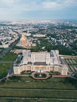 Aerial view of the monumental Palace of the Parliament standing proudly amid Bucharest's urban sprawl, framed by the Orthodox Cathedral, Bucharest, Bucharest, Romania.