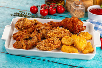Golden crispy fried chicken mix - wings, drumsticks, nuggets and strips