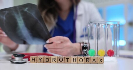 Wooden cubes show Hydrothorax drawing focus to pleural fluid condition. X-ray sheet and breath test tubes on desk highlight thoracic cavity study