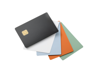 Assorted multi-colored credit cards arranged on a transparent surface financial banking concept