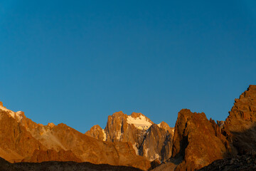 Rocky spires and Korona peak dominate the horizon. Ala-Archa Park, Ratsek camp, golden morning...