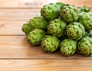 Fototapeta premium Fresh artichokes on a wooden table