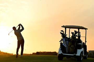 A Golfer silhouetted in action