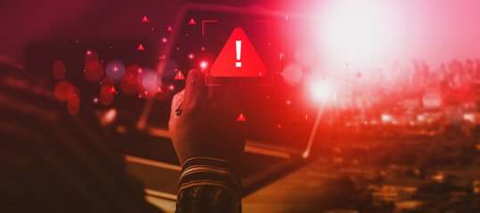 Cyber alert escalation concept. A person points at red warning symbol on glowing interface, representing urgent cybersecurity threat detection and system breach risk in urban technology setting.