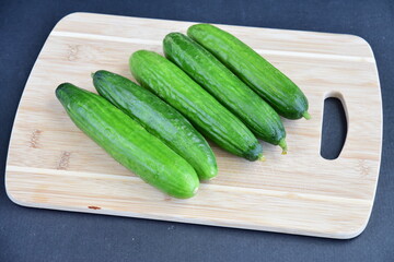 Cucumbers on wooden board