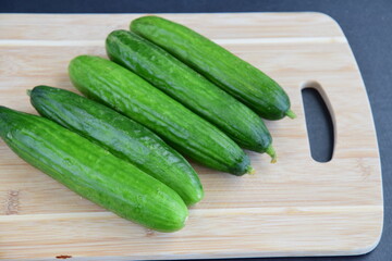 Cucumbers on wooden board