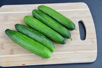 Cucumbers on wooden board
