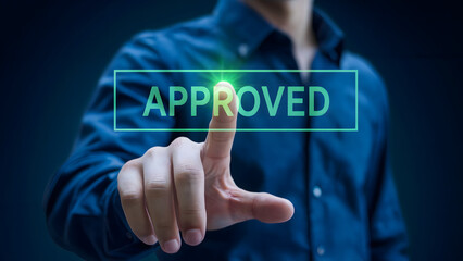 Man pressing the "Approved" button for success, validation, and acceptance