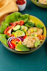 Buddha bowl with fish cakes, healthy food.