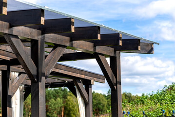 Fototapeta premium The terrace behind the house has visible beam connections, the roof is covered with polycarbonate.