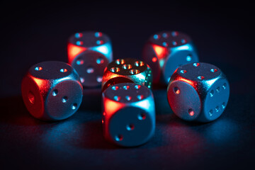 Colorful metallic dice cube on black background