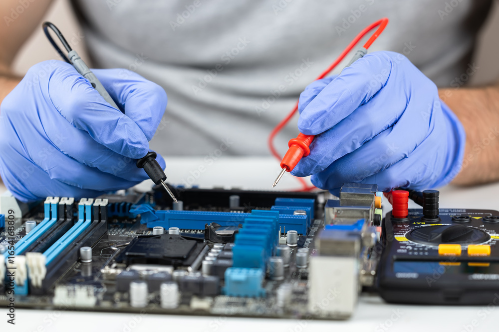 Poster testing motherboard with probes and multimeter, close-up of technician using probes on computer moth