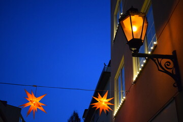old town street light and Christmas stars in blue hours mood