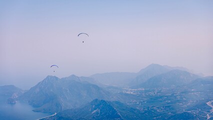 Paragliders Over Mountain Landscape
