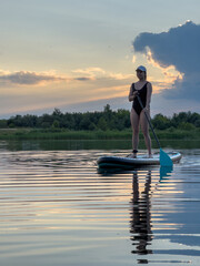 Paddleboarding at Sunset on a Tranquil Lake