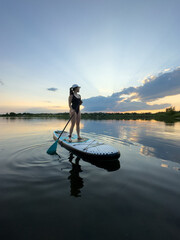 Paddleboarding at Sunset on a Tranquil Lake