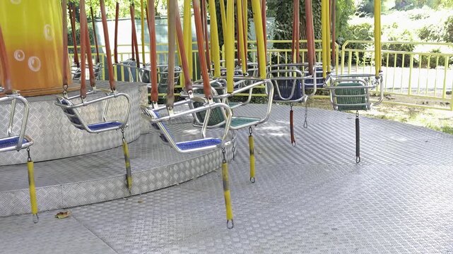 Empty Colorful Swing Ride Chairs at Amusement Park Carousel. Childhood Memories, Leisure and Entertainment Concept