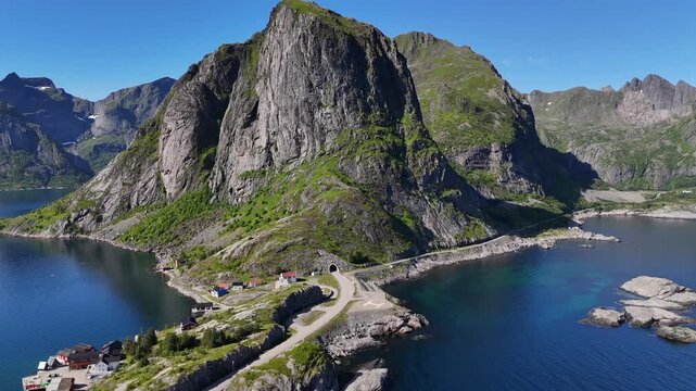 A large steep mountain near Hamn&oslash;y, a tunnel going through the large mountain and a small old road going around the mountain