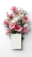 Pink and white flowers arranged around a blank card