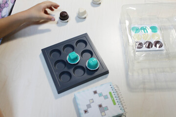 Board game, a visual perception exercise for visual therapy. Pieces of different colors and shapes...