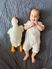 Baby Smiling with Plush Duck Toy