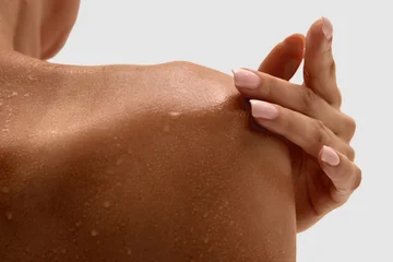 Fotobehang Nagelstudio Close up of female shoulder with wet skin touched by hand with manicured nails. Concept of dermatology, self care, beauty treatment, hydration, and clinical body examination.  © master1305
