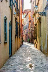 Narrow medeival street in old town of Lucca, Italy