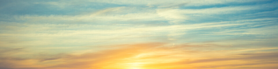 Colorful cloudy sky at sunrise. Horizontal banner