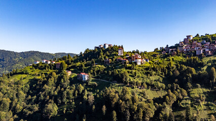 Camlihemin village nestled on lush green hillside in Rize, Turkiye, offering breathtaking aerial...