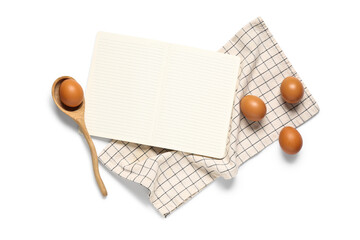 Composition with blank recipe book, eggs and napkin on white background