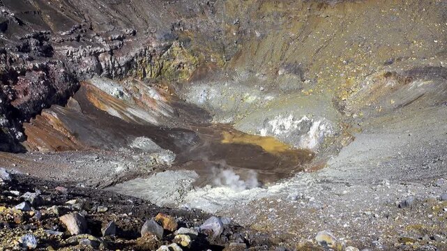 A volcano crater with an acid lake (explosion lake) and steaming fumaroles and hot springs. Sulawesi. Indonesia