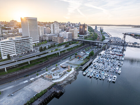 Aerial view of the marina filled with boats contrasting with the city skyline and the Thea Foss Waterway, Tacoma, Washington, United States.