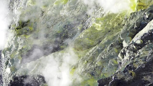 A volcano crater with an acid lake (explosion lake) and steaming fumaroles (solfatare) and hot springs. Sulawesi. Indonesia