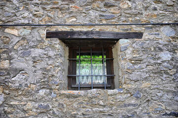 close up view of narrow ancient window on stonewall