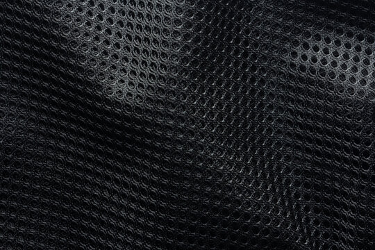 Black mesh fabric with a textured pattern in macro view, commonly used in sportswear