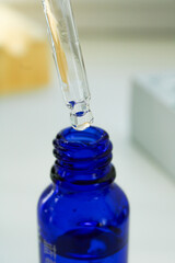 Blue glass dropper bottle with pipette for essential oils or skincare serum