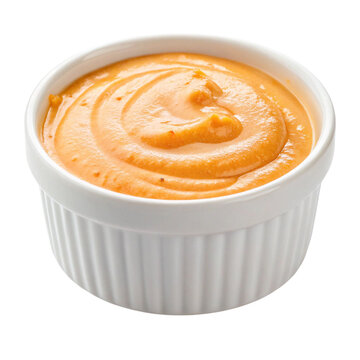 A ramekin filled with creamy orange sauce or dip isolated on transparent background