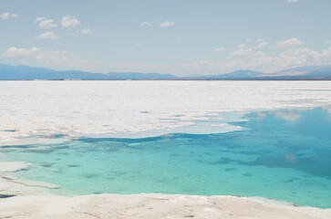 Salt flat with turquoise water and mountains in northern Argentina