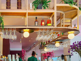 Modern bar interior with glassware, bottles and ambient lighting in stylish warm tones. Concept of bar interior, contemporary lifestyle