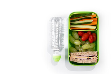 Healthy Lunchbox for school with sandwich,fruit and vegetables isolated on white background. Top...