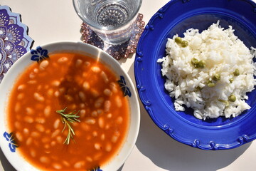 Healthy Meal Beans with Tomato Sauce and Rice in blue plate top view