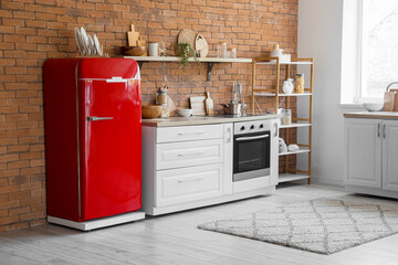 Interior of kitchen with retro fridge, counter and shelf